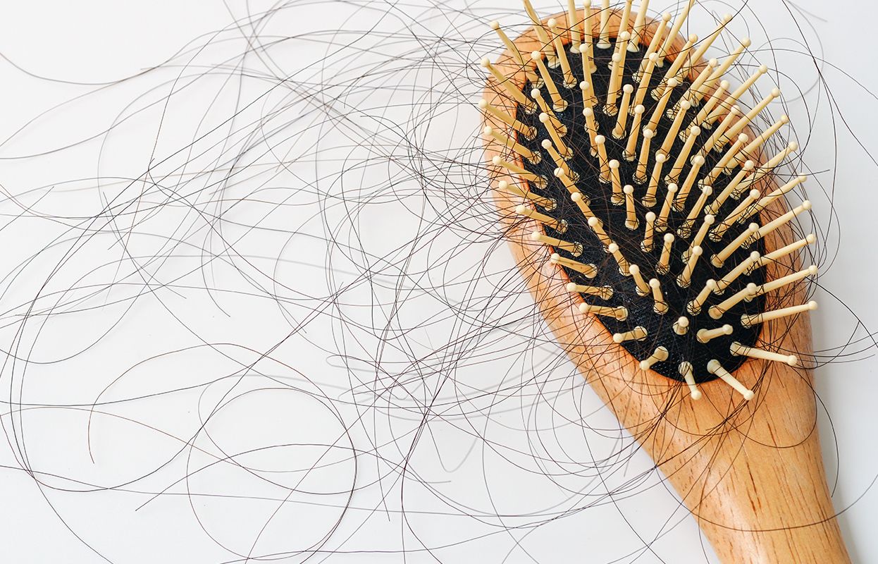 A comb or brush with significant broken hair on it