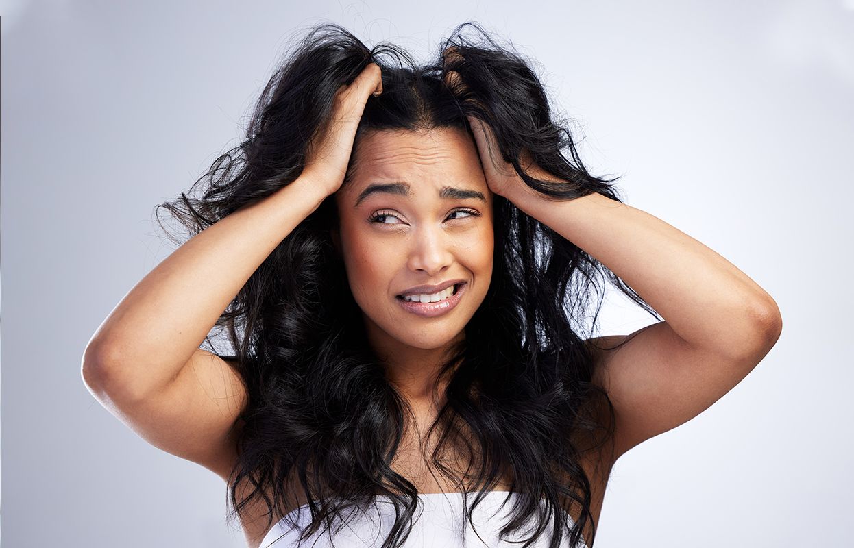 An irritated woman with itchy and dry hair