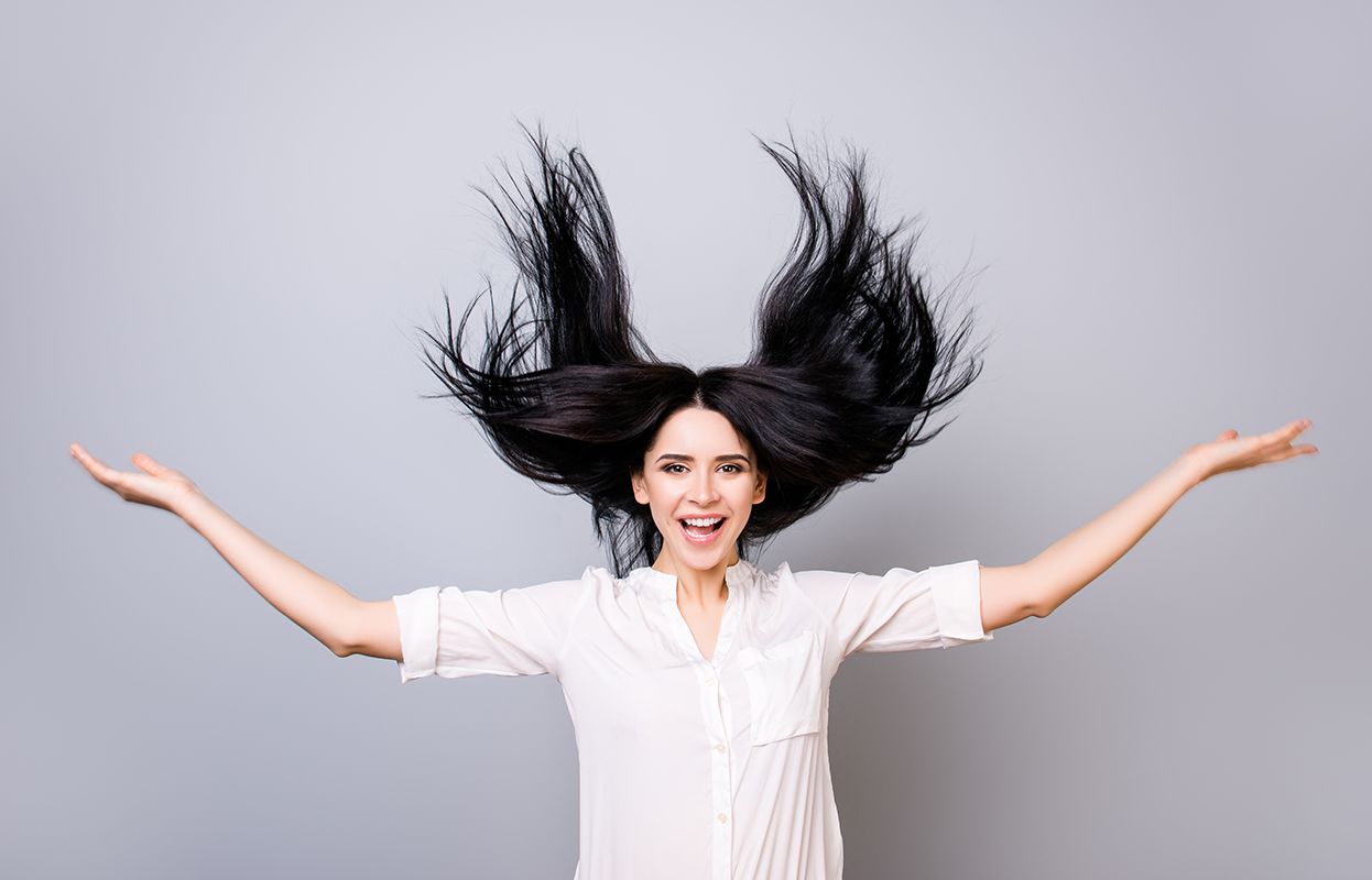 Happy woman flaunting her hair