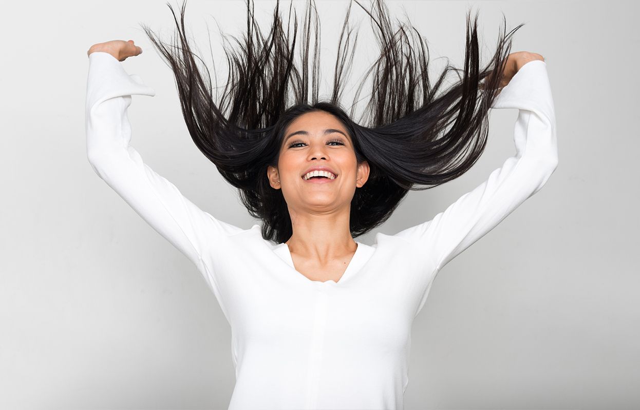 A happy woman flaunting long and strong hair
