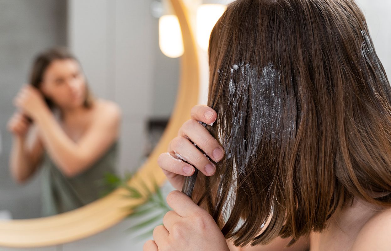 Woman applying something to her hair