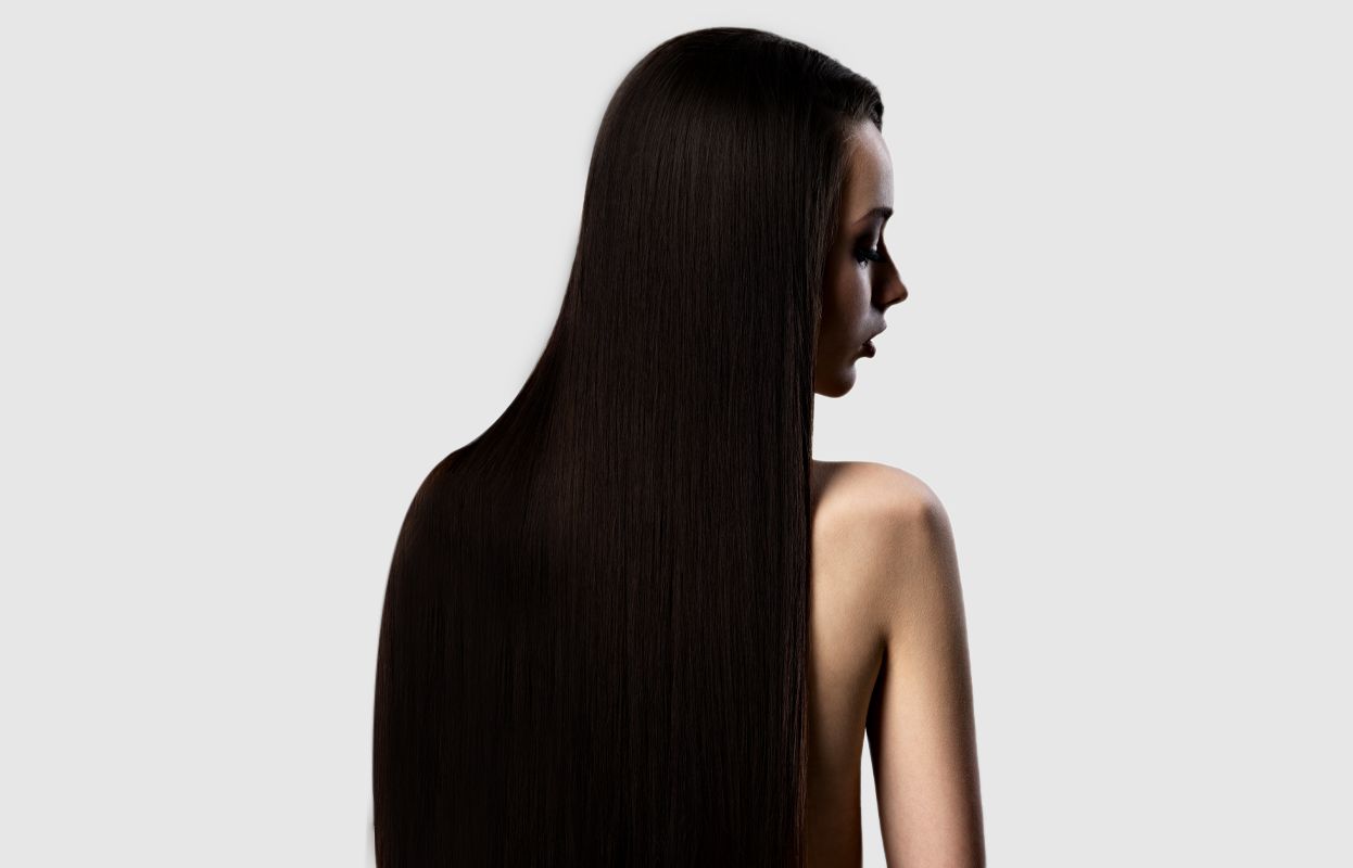 A close-up shot of a woman with long hair (preferably from the back)