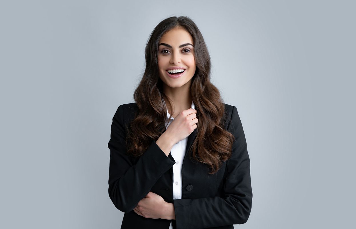 A happy woman in a business suit with healthy hair