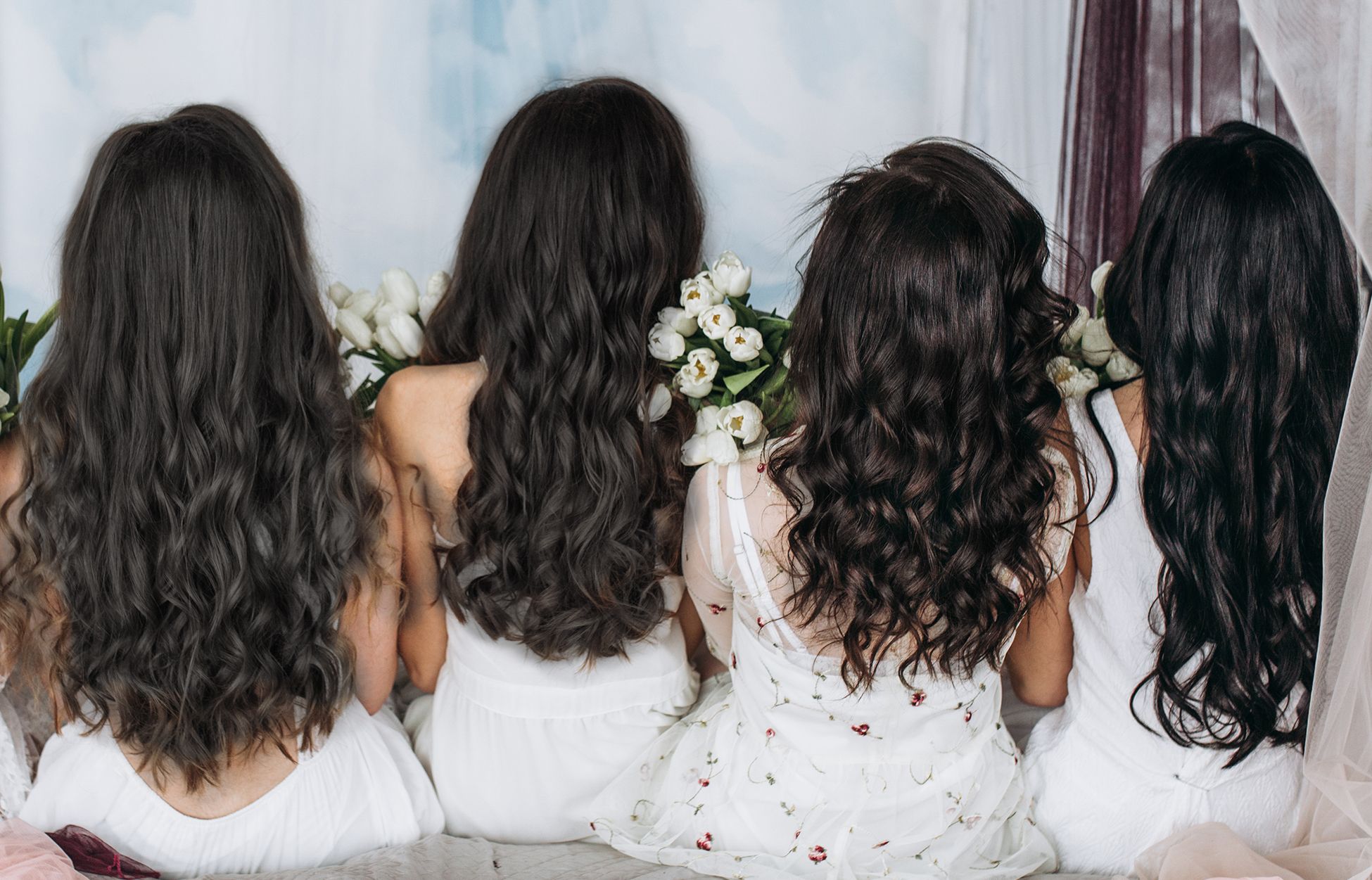 3 to 4 women with long shiny hair, with their backs to the camera